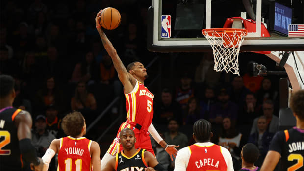Feb 1, 2023; Phoenix, Arizona, USA; Atlanta Hawks guard Dejounte Murray (5) slam dunks the ball against the Phoenix Suns in the first half at Footprint Center.